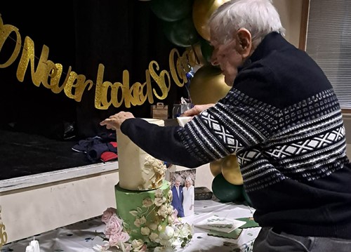 Duncan Hilling cutting his 100th birthday cake