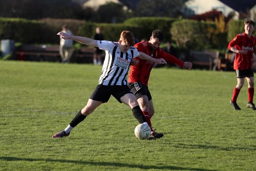 Neyland's Fletcher Picton holding off a Carew player